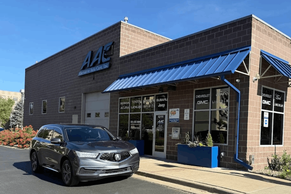 Japanese auto repair in Thornton, CO at Alternative Auto Care. Image of the shop exterior with a gray Acura SUV parked near the entrance, highlighting professional vehicle service and maintenance.